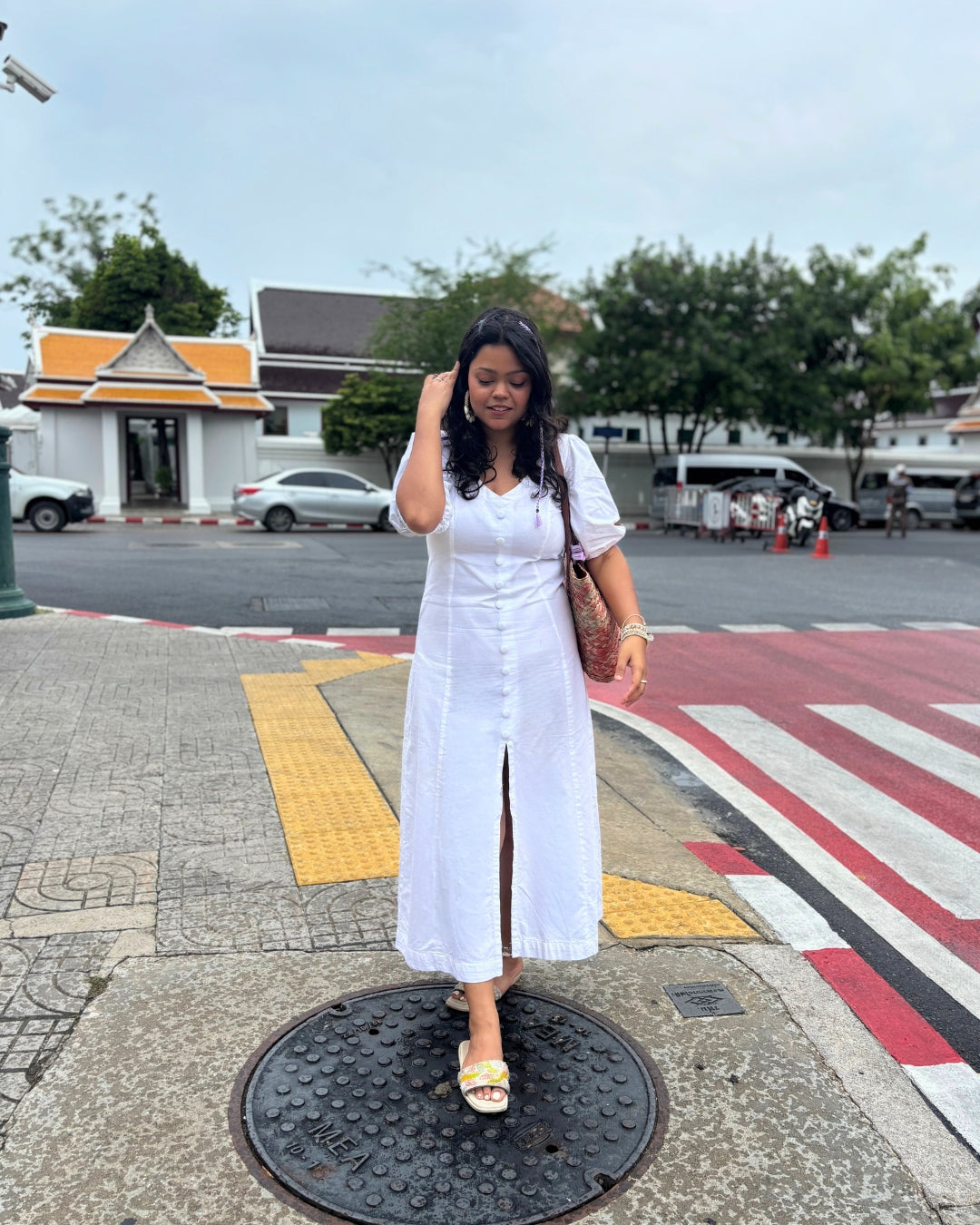 Elegant white Alyssa Button Down Maxi Dress in soft cotton with a V-neckline, button-down front, and front slit, featuring a flattering A-line silhouette.