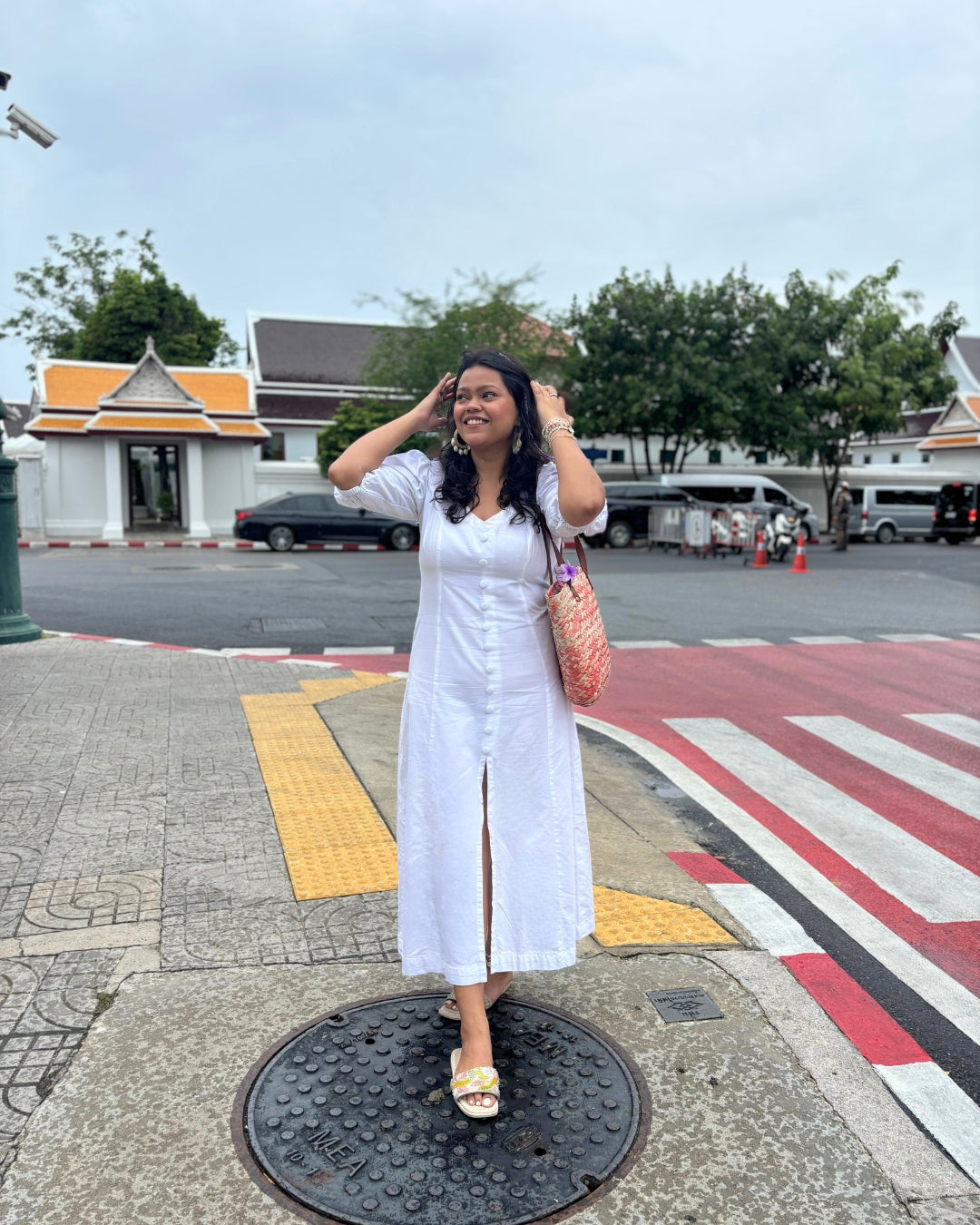 Elegant white Alyssa Button Down Maxi Dress in soft cotton with a V-neckline, button-down front, and front slit, featuring a flattering A-line silhouette.